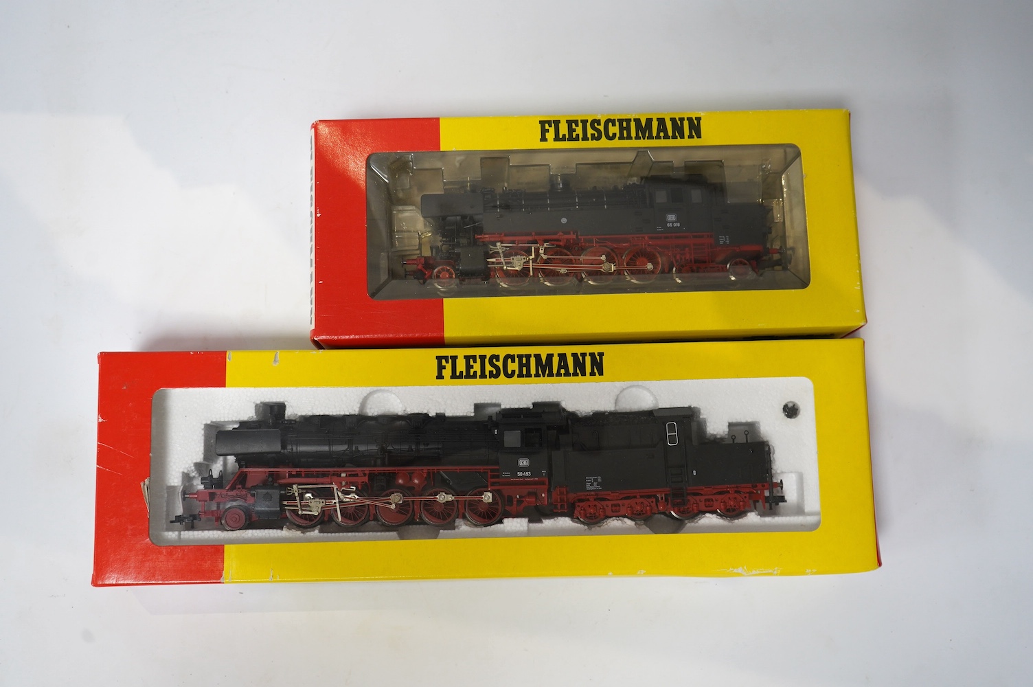 Two boxed Fleischmann HO gauge railway German DB locomotives; a 2-10-0 loco, 50 493, (4177), and a 2-8-4T loco, 65 018, (4065), together with a quantity of useful Fleischmann ballasted track sections, including double po